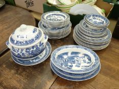 A quantity of Wedgwood 'Willow' pattern dinnerware including dinner plates, soup bowls, lidded dish,