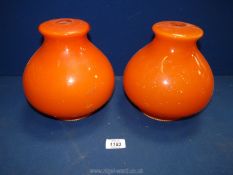 A pair of orange glass ceiling lights, some chips, 8 1/2" high.