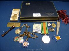 An un-named Defence medal, WWI Red Cross medal, silver and enamelled medals,