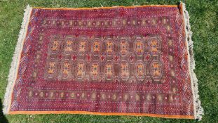 A chocolate brown ground Eastern rug decorated with elephant foot pattern guls, a/f., approx.