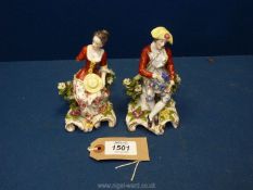 A pair of Chelsea figures of a lady and gentleman with the gold anchor mark to the back of each.