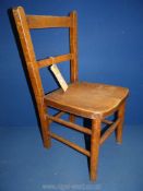 A Victorian child's chair with elm seat.