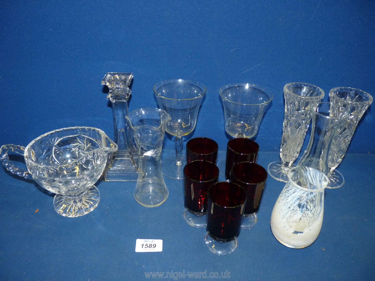 A small quantity of glass to include five cranberry sherry glasses, bud vases, two glass goblets,