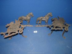 A quantity of metal items including a pair of dragon trivets and a pair of horse ornaments.