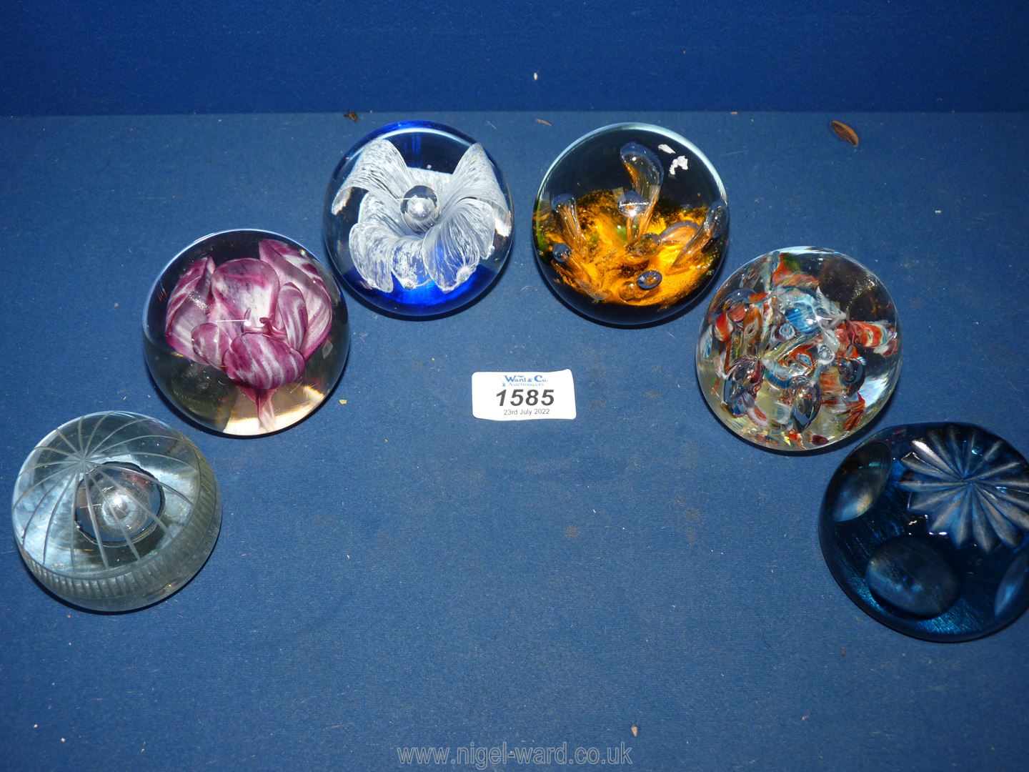 Six paperweights including Strathearn pink floral,blue and white bubble, orange etc.