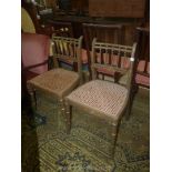 A pair of elegant olive green and gilt detail side Chairs having caned seats,