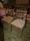 A pair of elegant olive green and gilt detail side Chairs having caned seats,