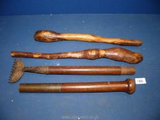 Two African clubs and an Edwardian carpet stretcher in two parts.