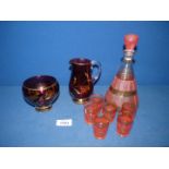 A pretty pink/gold decanter and 6 shot glasses, together with a glass lustre jug and sugar bowl.