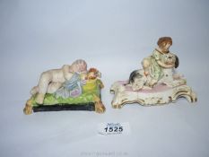 A Staffordshire porcelain figure of sleeping Putti on a green tasseled cushion,