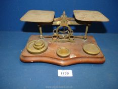 A set of brass postage Scales with wooden base and weights.