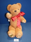 A Merry Thought brown Teddy Bear with red bow and windup chimes, dated from 1991 onwards, approx.