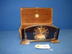 An unusual glass framed Junghans Clock in original case with copper coloured face.