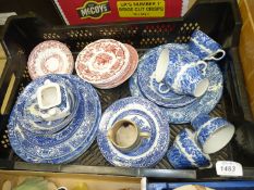 A quantity of blue and white china to include Old Willow pattern plates, bowls,