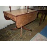 A circa 1900 Mahogany dropleaf Table having a drawer to one end,