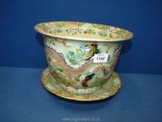 An oriental jardiniere with plate, decorated with embossed dragons, butterflies, flowers etc.