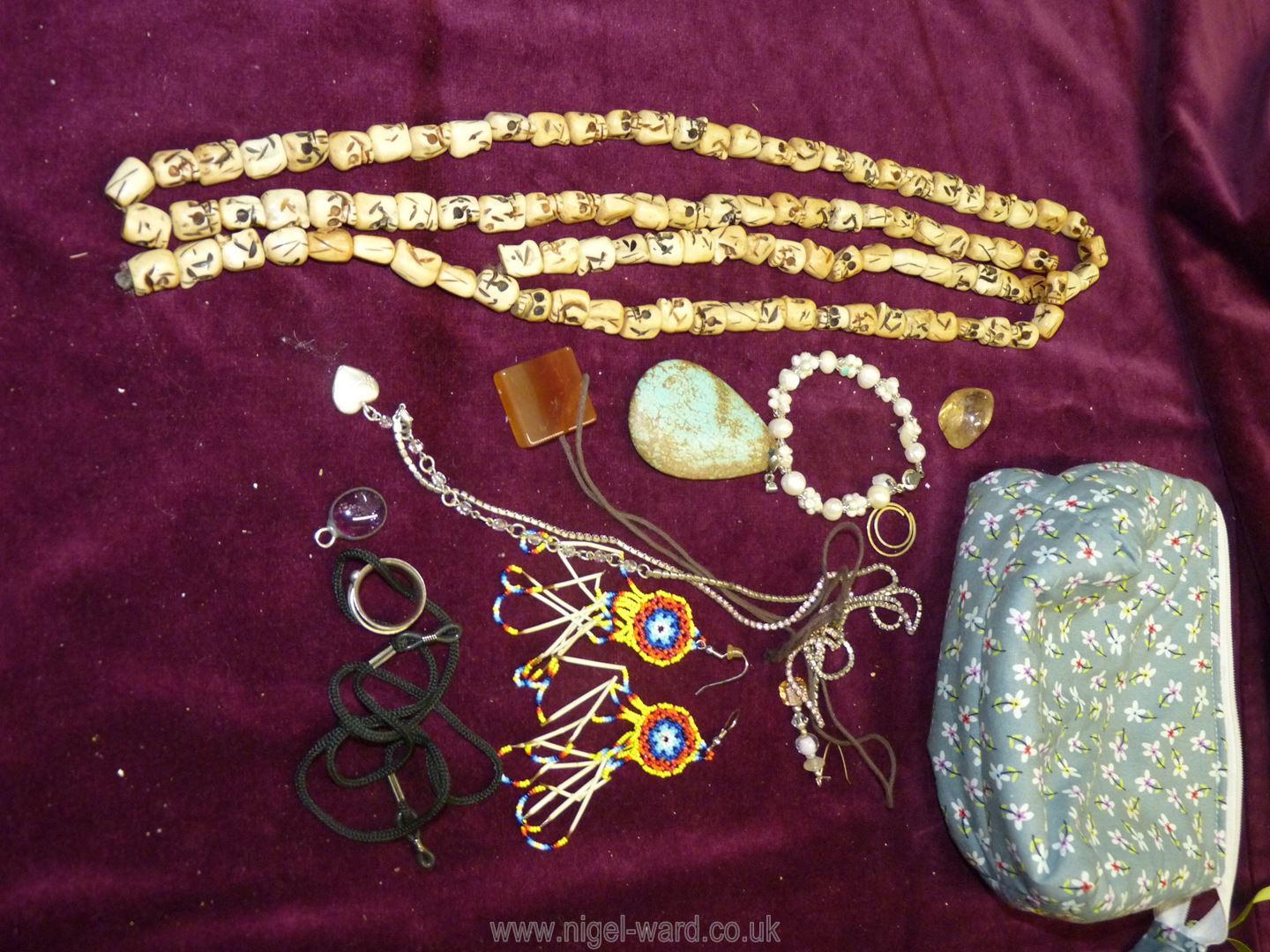 A small quantity of costume jewellery including skull shaped beads necklace, stone pendant etc.