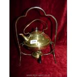 A brass kettle on stand.