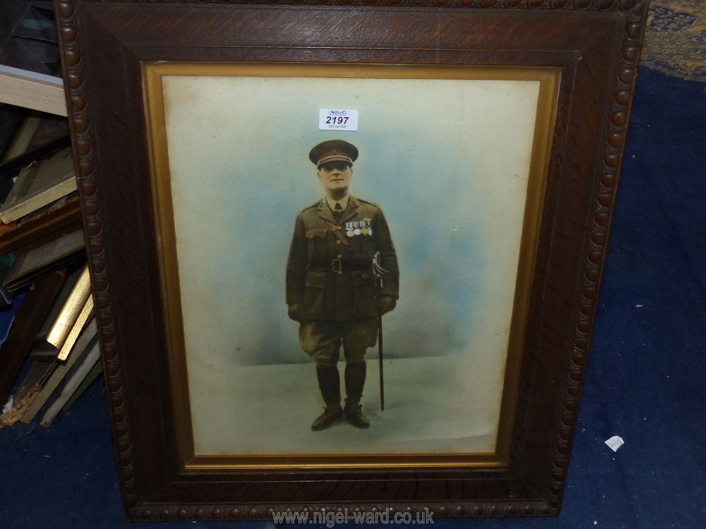 A carved wooden framed coloured Lithograph of a military officer. - Image 3 of 3