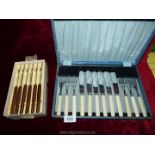 A cased set of six fish knives and forks and a boxed set of six stainless steel knives with wooden