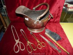 A copper helmet shaped coal bucket and miscellaneous fire tongs, brush etc.