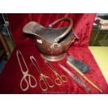 A copper helmet shaped coal bucket and miscellaneous fire tongs, brush etc.