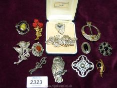 A quantity of brooches including a Celtic style pewter brooch, pewter owl brooch,