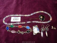 A small quantity of jewellery including a bracelet of white metal with polished stones all carved