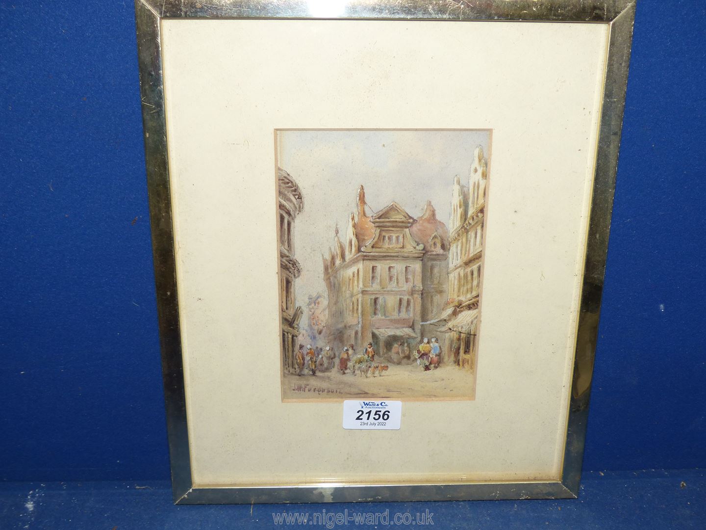 A small framed and mounted Watercolour of a Street scene with figures outside buildings and a