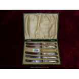 A boxed set of five silver handled butter knives- one missing- Sheffield 1918 to maker John Biggin-