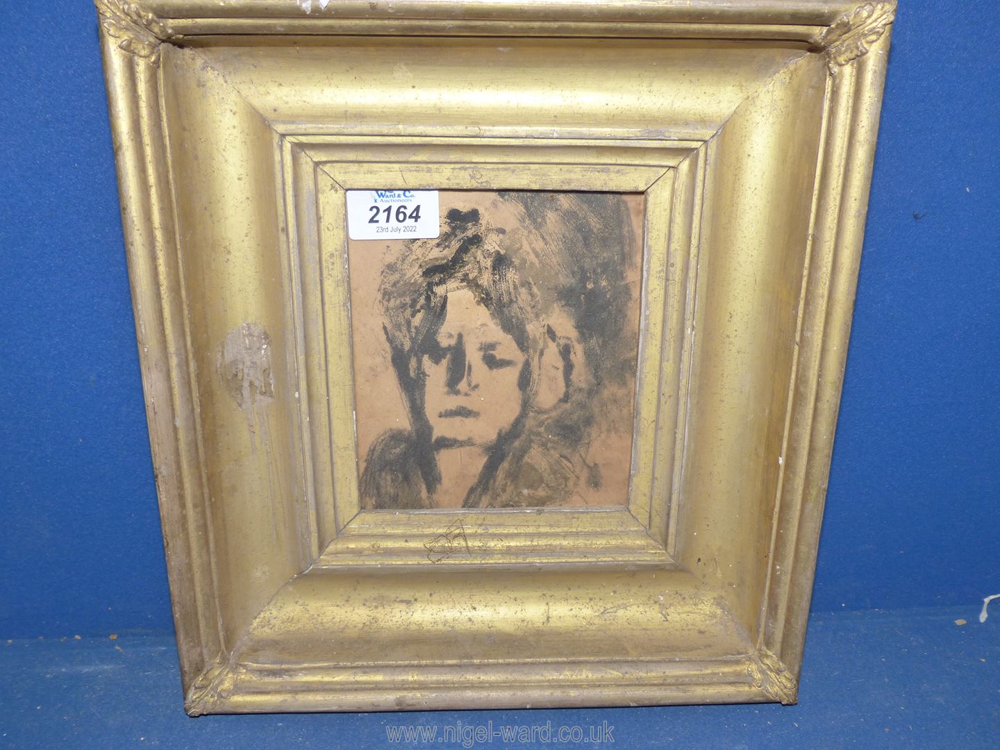 A gilt framed portrait of a Lady in black paint, faded inscription verso.