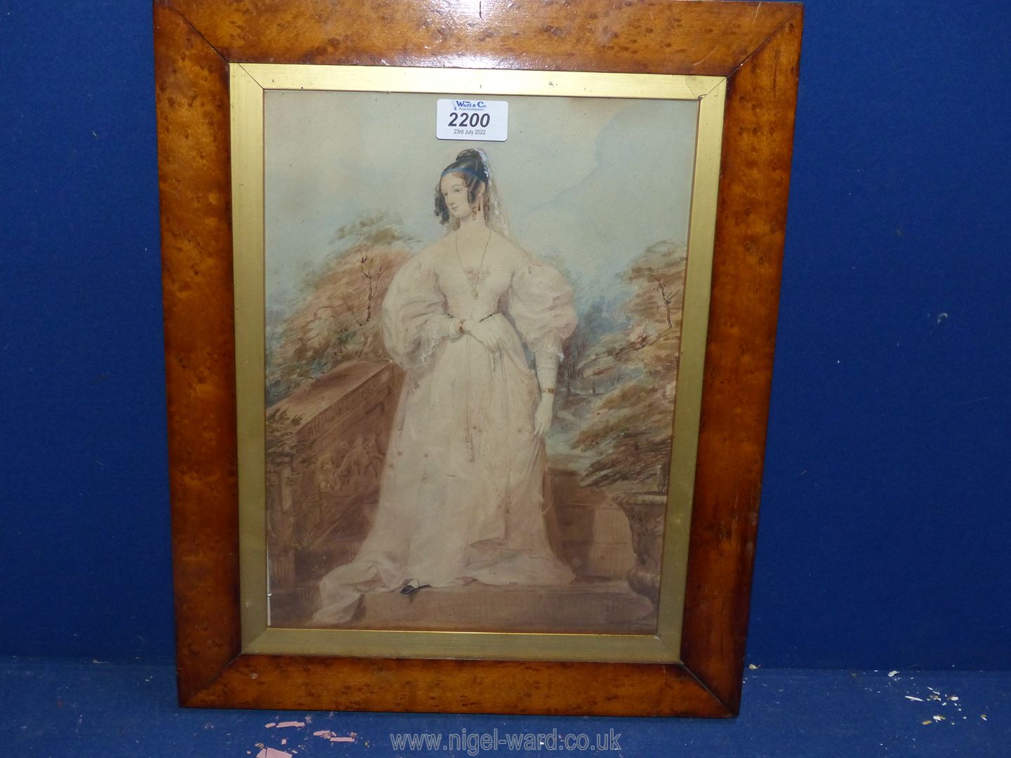 A wooden framed Watercolour of a Victorian Lady in elegant dress in garden, no visible signature.