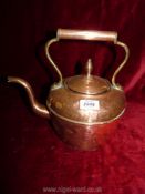 A copper kettle with lid and handle.