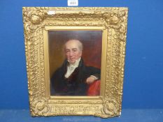 An ornate gilt framed oil on board depicting a three quarter portrait of a gentleman sat in a red