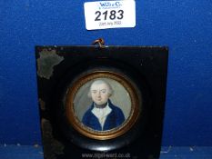 An ebonised papier mache framed circular well-executed Portrait Miniature of a middle aged