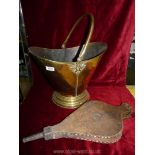 A brass coal bucket and a pair of bellows.