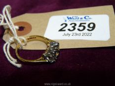 An 18ct gold three stone diamond ring with four tiny sapphires, size 'O',