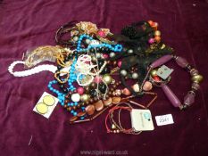 A pink box of costume jewellery including beads, bangles etc.