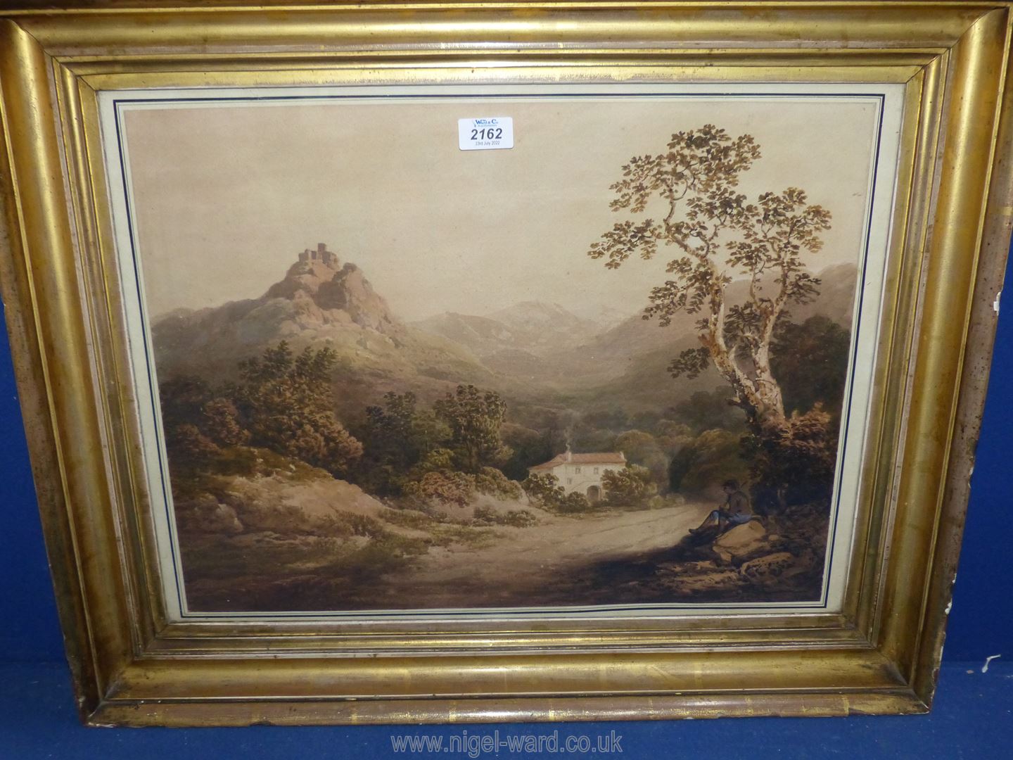 A framed Watercolour depicting Villa in a valley with mountains in the distance and a young boy sat
