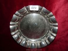 A metal hammered dish stamped 'Made in England', 10" diameter.