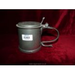 A vintage Commonwealth style Pewter Tankard with scroll handle and Charles medallion under the lid.