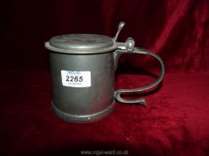 A vintage Commonwealth style Pewter Tankard with scroll handle and Charles medallion under the lid.