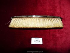A silver backed clothes brush, Birmingham 1918, makers Charles Perry & Co.