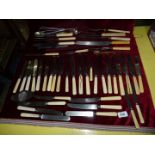 A quantity of cutlery, mostly bone handled knives, plus meat carvers and everyday utensils.