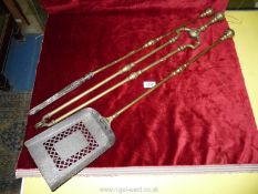 A set of brass handled fire irons.