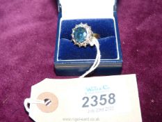 A diamond and sapphire ring on unmarked gold band,