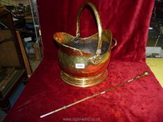 A brass coal bucket and poker.