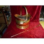 A brass coal bucket and poker.