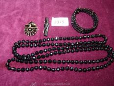 A small quantity of costume jewellery including black bead necklace and cuff and polished black