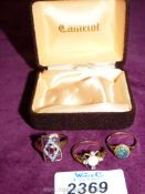 Three dress rings including 9ct gold set with opals, red stones etc.